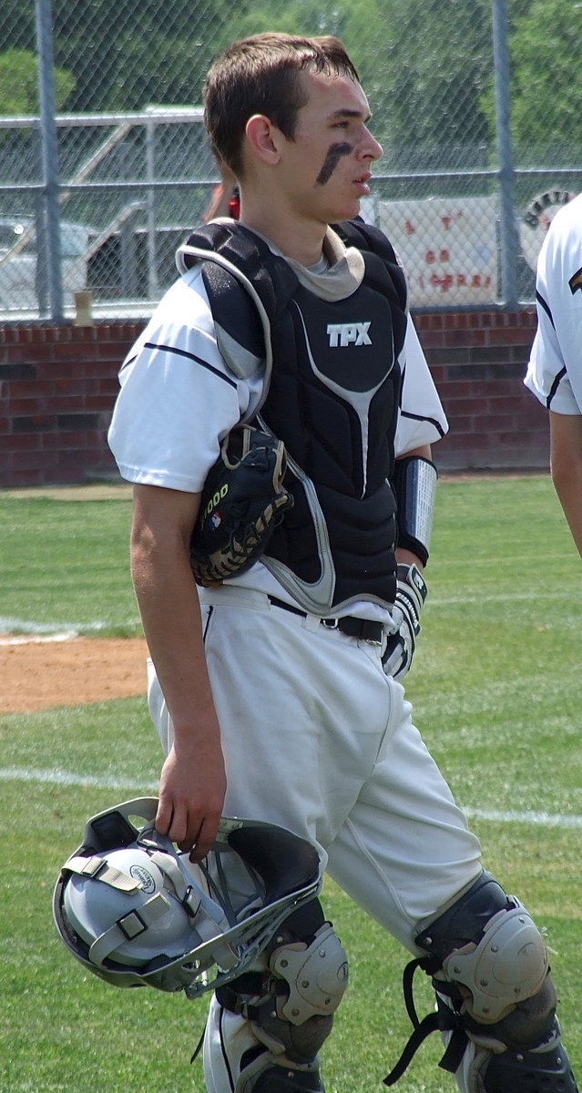 Image: Catcher Ryan Connor(17) takes a breather during a break in the action.