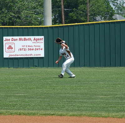 Image: Backup center fielder, Kyle Fortenberry(14), a sophomore, catches a popup during the pre-game warmups.