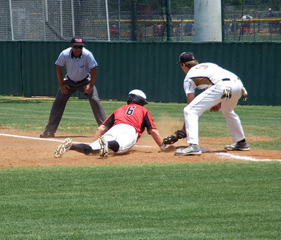 Image: Italy’s Cole Hopkins(9) awaits the call from the umpire in a close call at the bag.