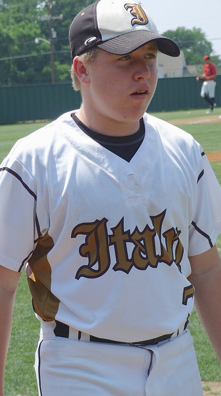 Image: Gladiator sophomore John Escamilla(7) finishes warming up his pitcher.