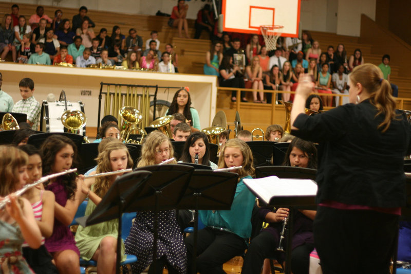 Image: The 7th &amp; 8th grade band, directed here by Erica Miller, wowed the crowd with their music.