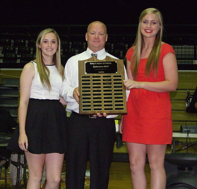 Image: Softball assistant coach Michael Chambers presents Kelsey Nelson and Madison Washington with the 2013 Defensive MVP award in softball.