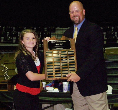 Image: Sophomore Tara Wallis receives the 2013 girls Powerlifting MVP Award from Coach Hank Hollywood.