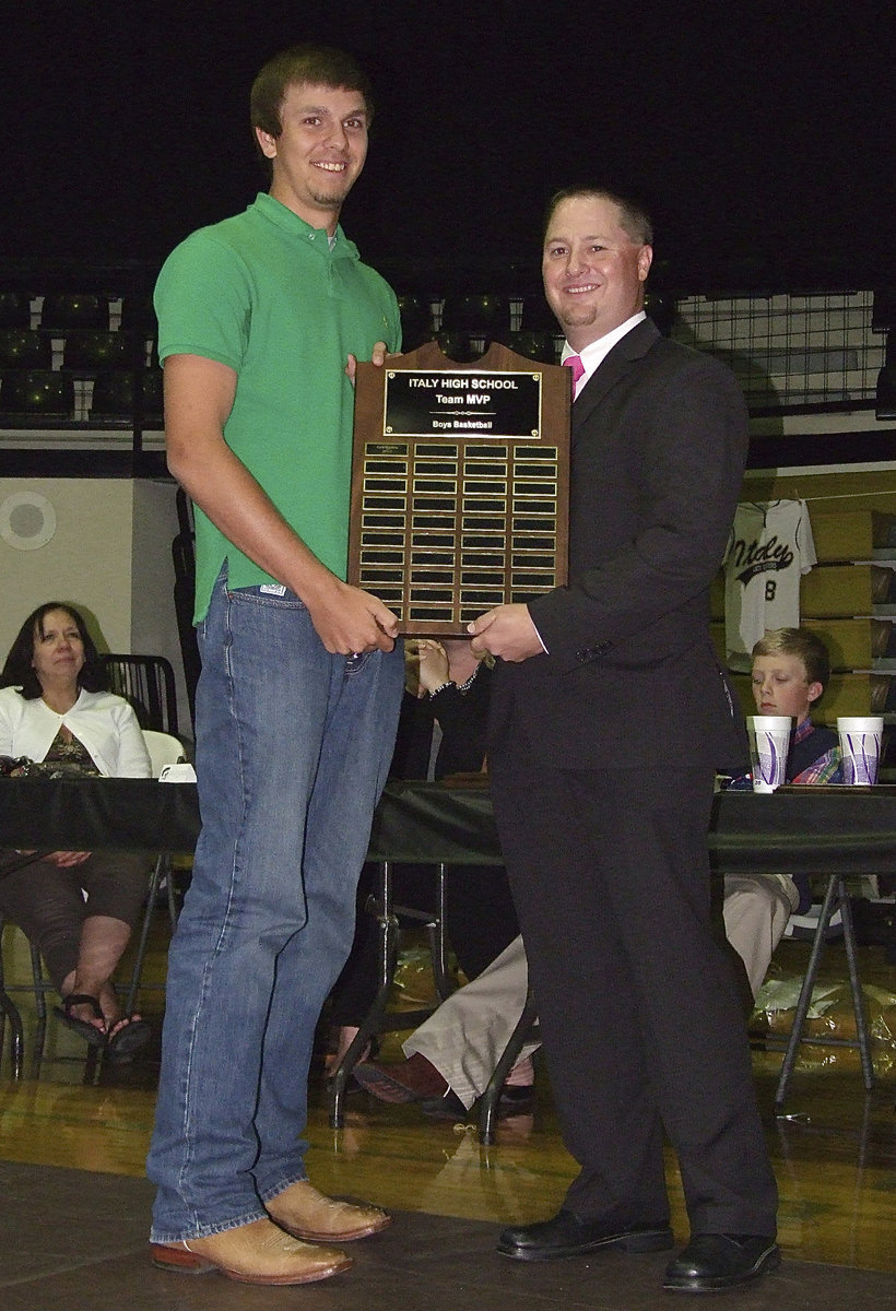 Image: Senior Cole Hopkins receives the Boys Team MVP Award in basketball with assistant varsity basketball coach Josh Ward making the presentation.