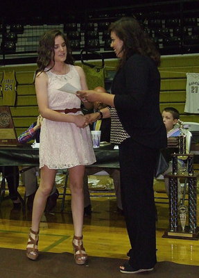 Image: Freshman Cassidy Childers is recognized as a memebr of the Lady Gladiator JV Volleyball team with assistant coach Tina Richards presenting Childers with her certificate.
