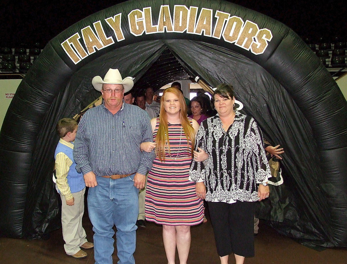 Image: Senior Katie Byers is escorted by her father and mother, Brent and Nancy Byers, to begin the banquet.