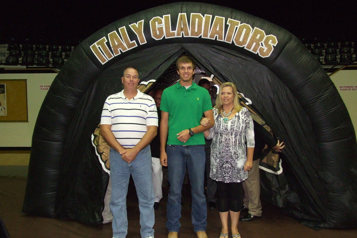 Image: Senior Cole Hopkins is escorted by his father and mother, Brad and Cassandra Hopkins, to begin the banquet.