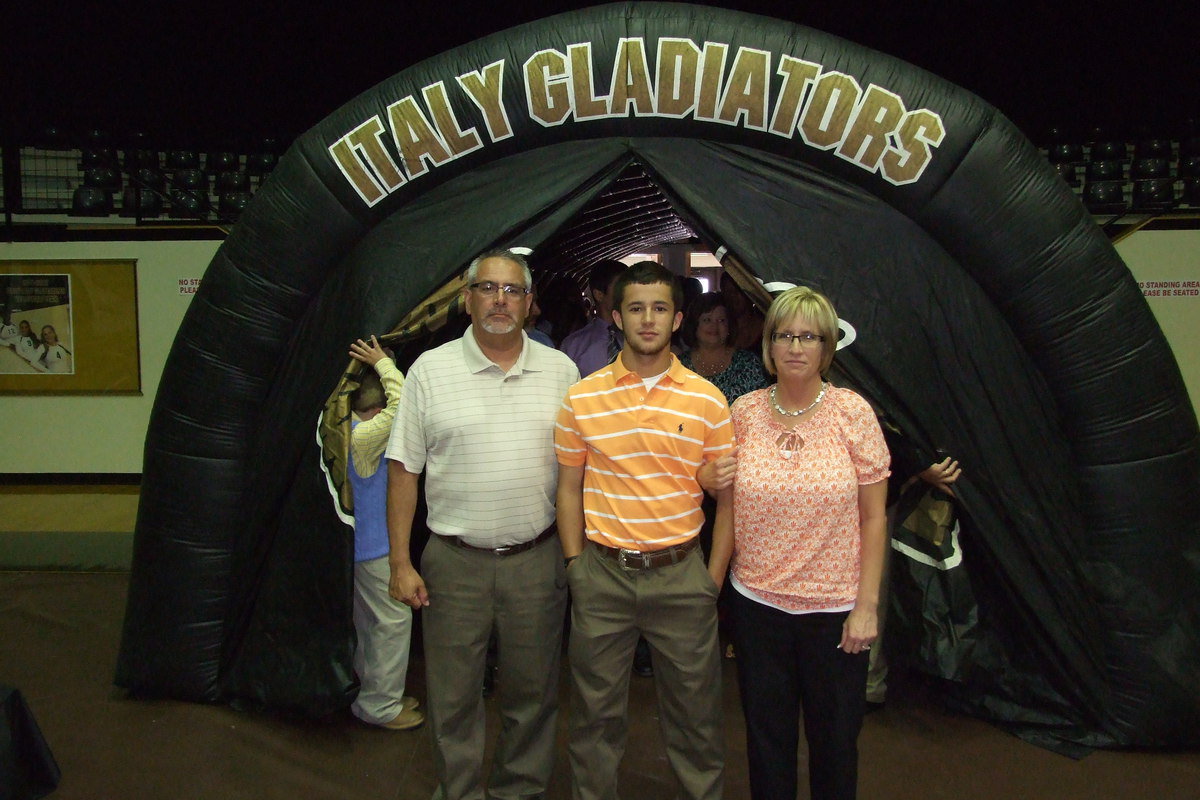 Image: Senior Caden Jacinto is escorted by his father and mother, Vincent and Lisa Jacinto, to begin the banquet.