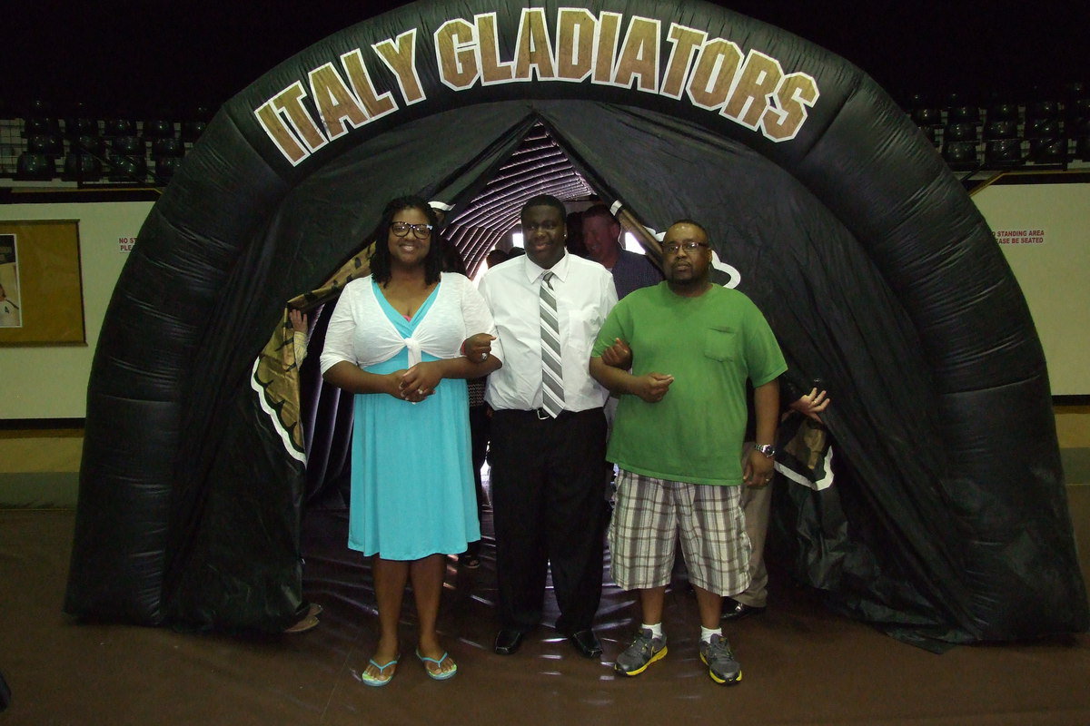 Image: Senior Adrian Reed is escorted by his father and mother, Brendetta and Adrian Reed, Sr., to begin the banquet.