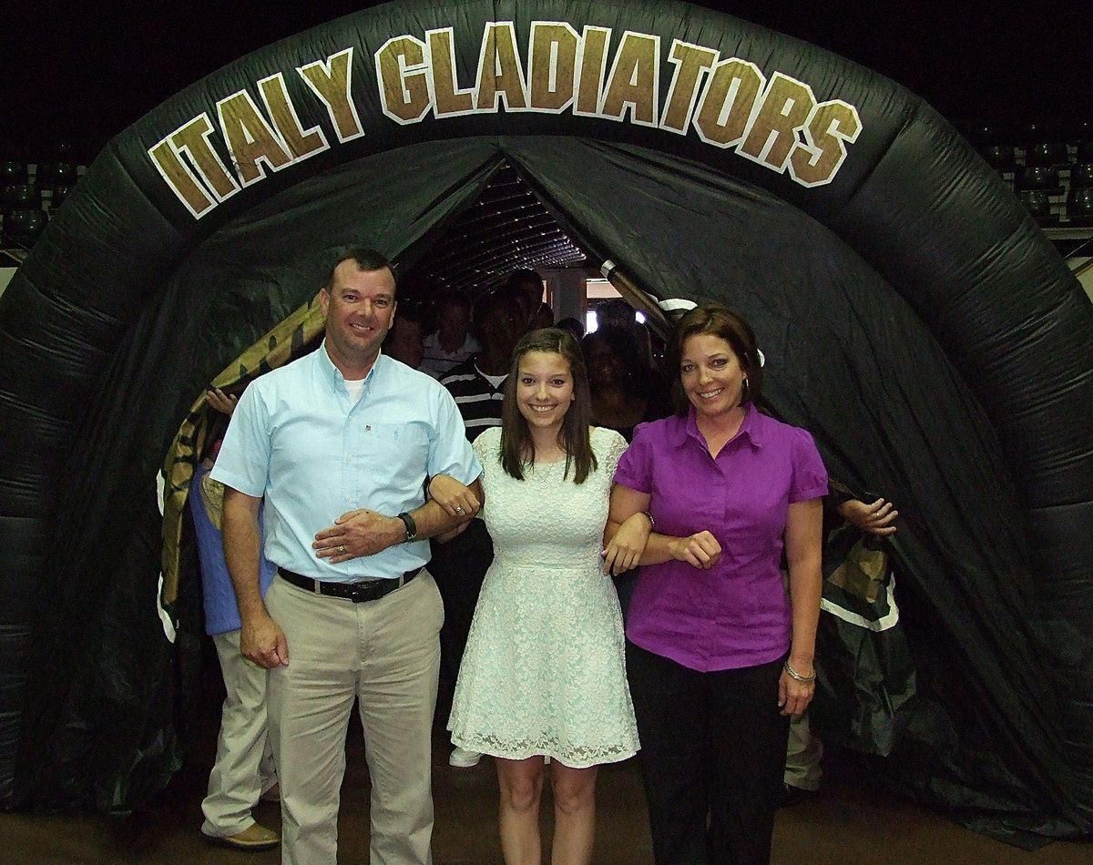 Image: Senior Morgan Cockerham is escorted by her father and mother, Paul Cockerham and Dustie Jones, to begin the banquet.