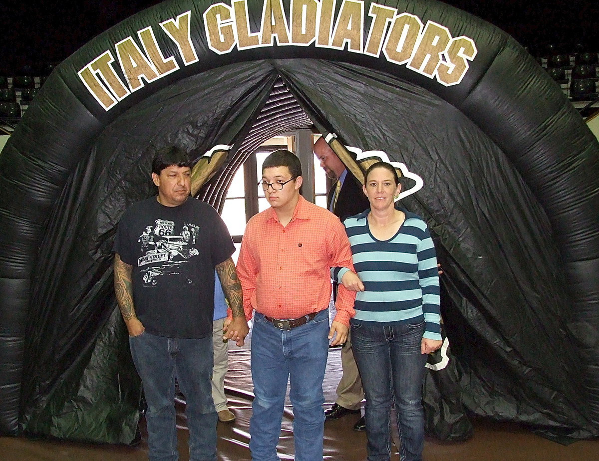 Image: Senior Blake Vega is escorted into the banquet by his parents.