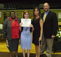 Image: CBI instructors Brenda Davis and Teresa Young, along with AD/HFC Coach Hank Hollywood, present CBI student Katie Connor with a certificate as she stands proud with her Special Olympic medals. Connor was also presented her Italy Gladiator letterman jacket which certainly fired up the Italy Coliseum crowd.