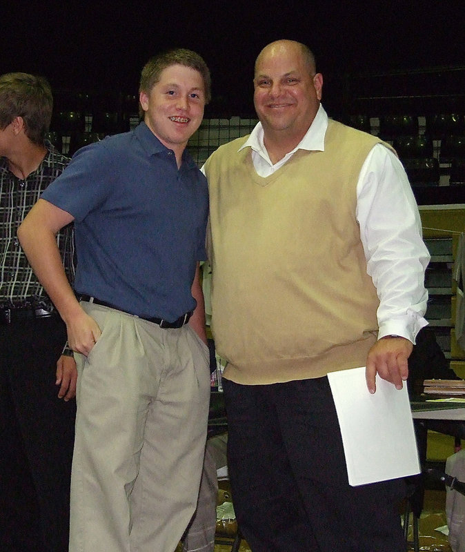 Image: Sophomore John Escamilla is presented his certificate as a member of the Italy Baseball team from assistant baseball coach Brian Coffman.