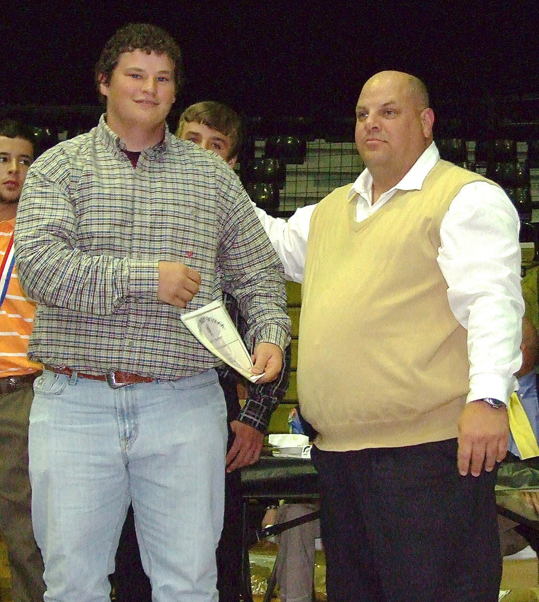 Image: Sophomore John Byers is awarded a certificate as a member of the Italy Baseball team from assistant coach Brian Coffman.