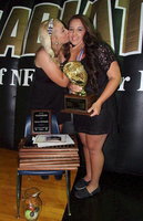 Image: Senior Alyssa Richards receives a congratulation kiss from 2012 graduate and sister Megan Richards with her little sister stacking up several awards during the 2013 Italy Athletic Banquet. What a career!