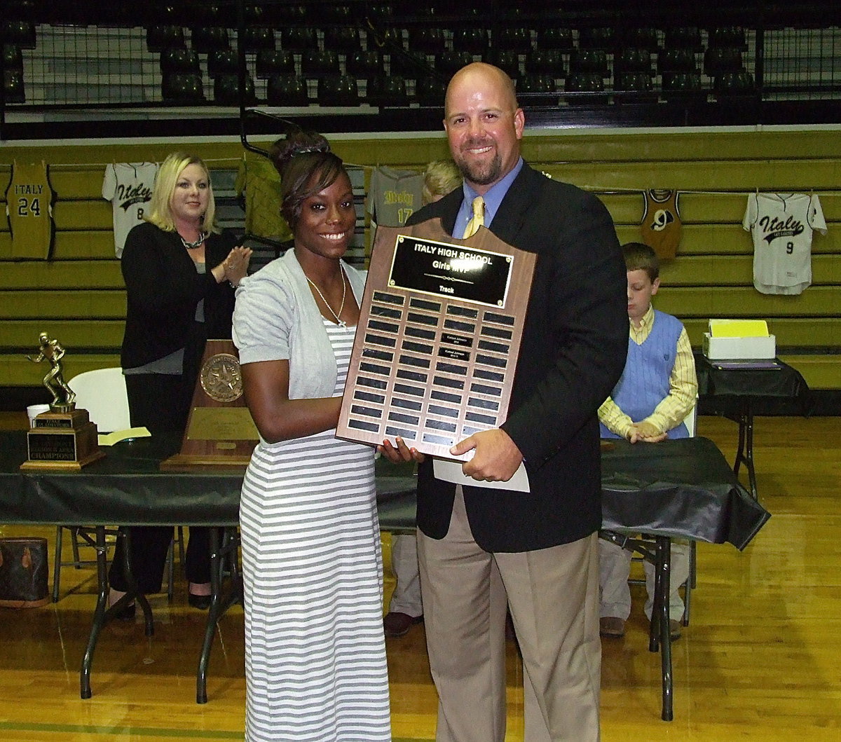 Image: Sophomore Kortnei Johnson is presented the girls Track MVP Award from Coach Hank Hollywood. Johnson earned two UIL State championship medals while breaking two state sprint records in both the 100 Meter Dash and the 200 Meter Dash.