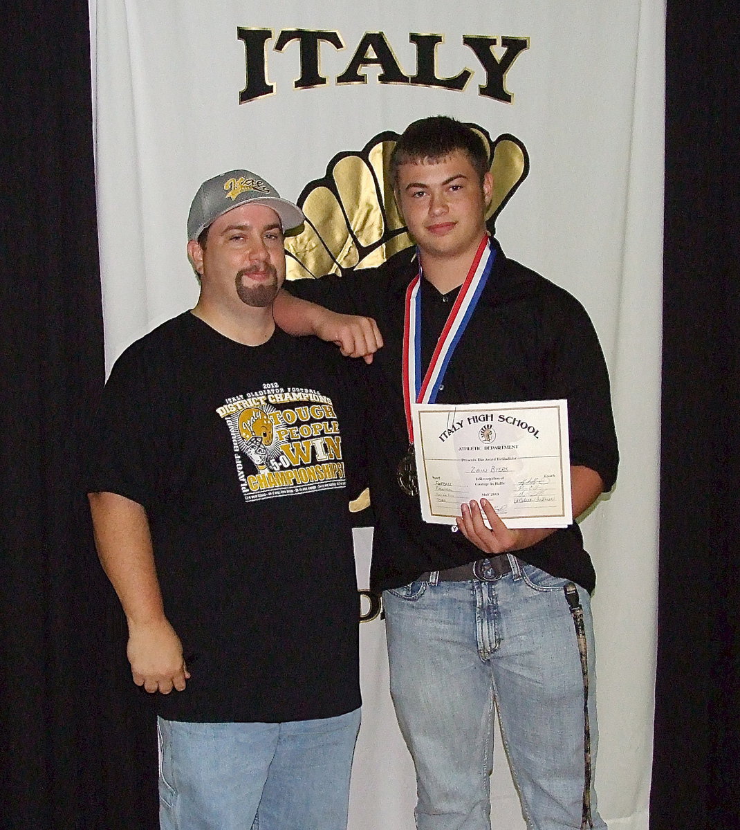 Image: Pictured with his father, Barry Byers, senior Gladiator, Zain Byers, displays his State semifinal medal and certificate of achievement.