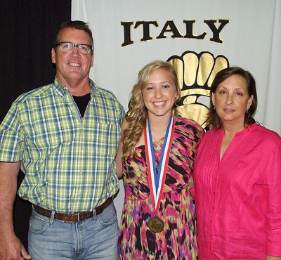 Image: Pictured with parents, Russ and Kelly Lewis, sophomore statistician, Jaclynn Lewis, displays her State semifinal medal.