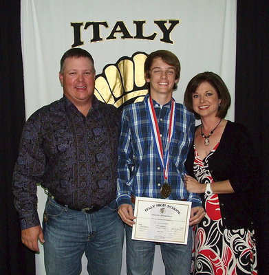 Image: Pictured with his parents, Joe and Andi Windham, is freshman Gladiator, Ty Windham, who displays his State semifinal medal and certificate of achievement.