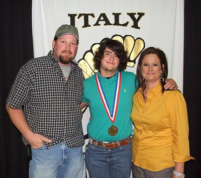Image: Pictured with his proud parents is sophomore Gladiator, Kyle Fortneberry, who displays his State semifinal medal and certificate of achievement.