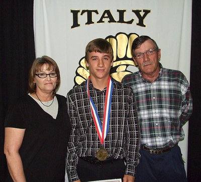Image: Pictured with his parents is freshman Gladiator, Levi McBride, who displays his State semifinal medal and certificate of achievement.