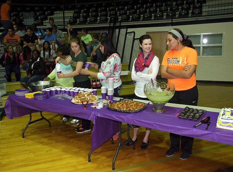 Image: IHS Teacher Vivian Moreland and schoolmates Taylor Turner, Monserrat Figueroa, Meagan Hooker and Alyssa Richards are ready to serve those attending Cole’s signing.