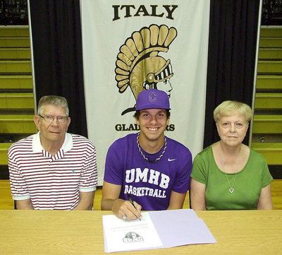 Image: Cole Hopkins is joined by his grandparents, Lawrence and Sandra Maricle, during his commitment signing to the University of Mary Hardin-Baylor to play basketball for the Crusaders.