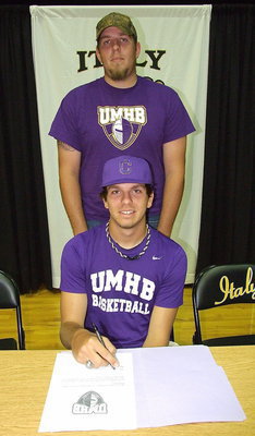 Image: Cole Hopkins with his older brother, Jacob Hopkins, during Cole’s signing of his letter of intent to play basketball for the University of Mary Hardin-Baylor Crusaders.