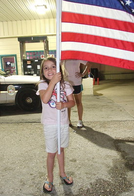 Image: Morgan Chambers, waves an American flag in anticipation of Birdman’s arrival.