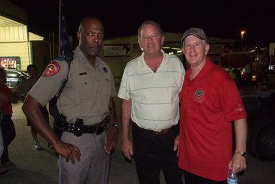 Image: DPS Trooper Otis White, City of Italy mayor James Hobbs and Rob Kyker, commissioner for the Texas Commission On Law Enforcement, are just moments away from the Birdman’s arrival at the Italy checkpoint setup outside Hobbs Feed &amp; Supply. The Italy checkpoint marked the 57 mile mark of Birdman’s route between Waco and Dallas.