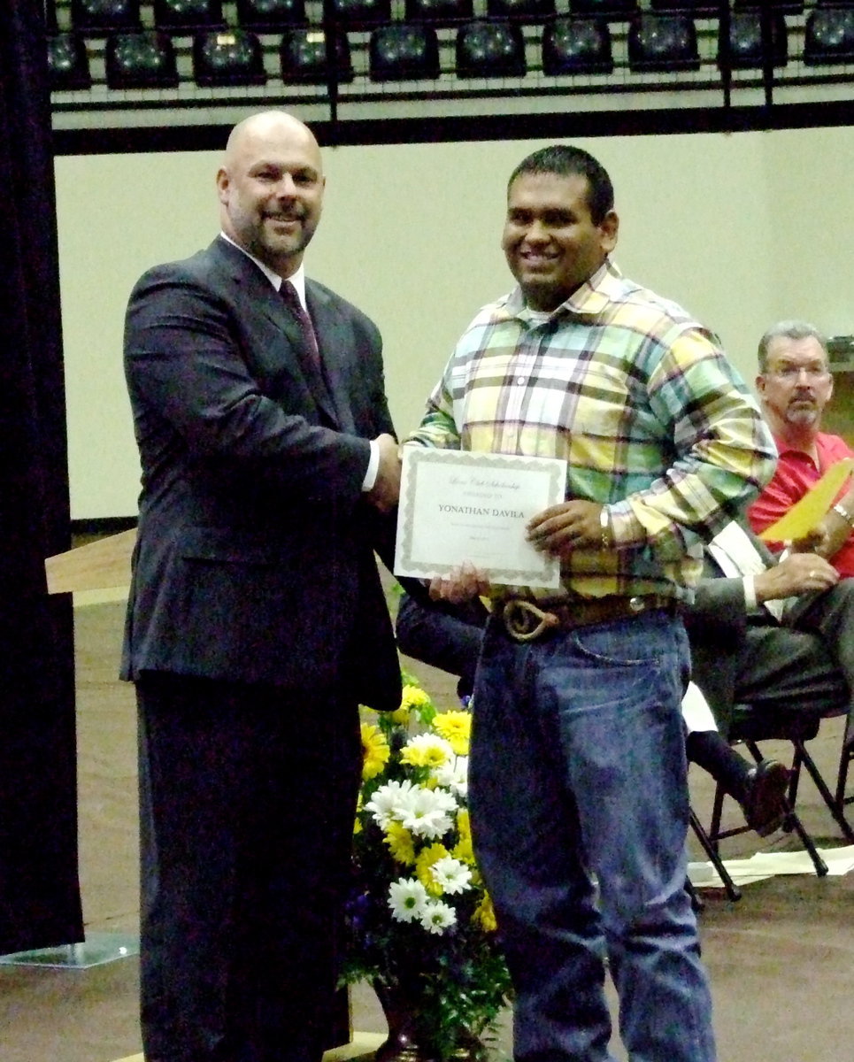 Image: IHS principal, Lee Joffre, presents the Lions Club Scholarship to graduating senior Yonatan Davila.