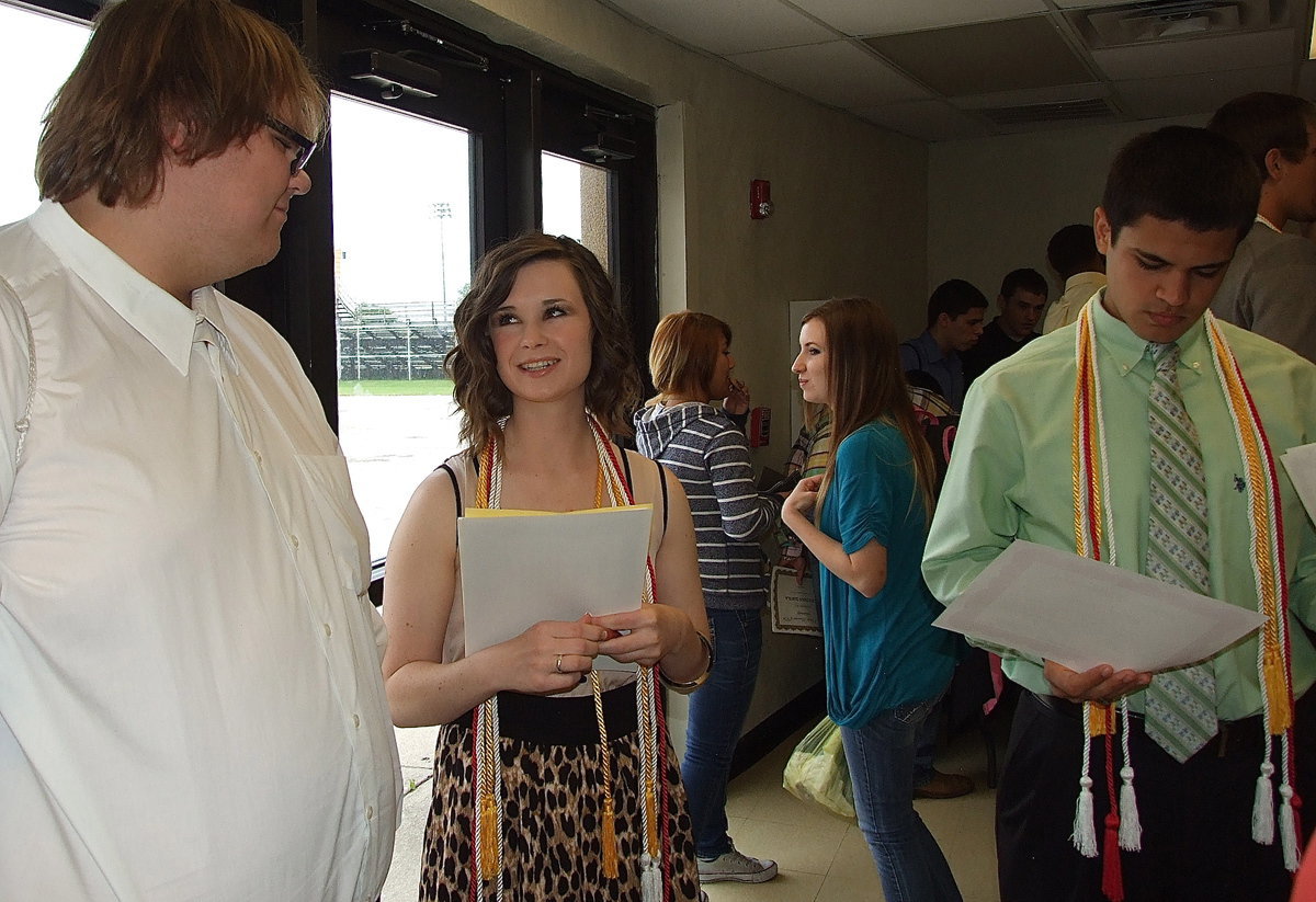 Image: Logan Owens, Meagan Hooker and Reid Jacinto prepare for their next steps after high school while visiting during the reception.