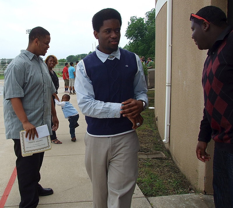 Image: Graduating seniors Timothy Fleming, Paul Harris and Adrian Reed prepare to face the challenges of life after high school.