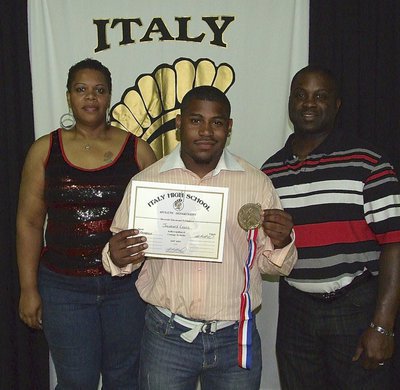 Image: Pictured with family members is senior Gladiator, Jalarnce Lewis, who displays his State semifinal medal and certificate of achievement.