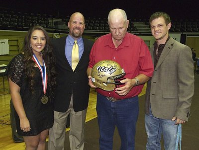 Image: Senior Alyssa Richards, AD/HFC Hank Hollywood and senior Chase Hamilton present dedicated Gladiator football fan, Richard Cook, with a Gladiator football helmet signed by all the players of the 2012 State semifinalists team.