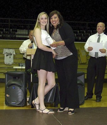 Image: Coach Tina Richards presents Kelsey Nelson with her all-district certificate Nelson earned for playing softball.