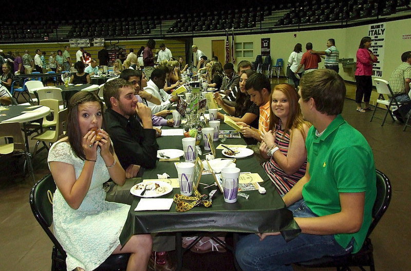 Image: Senior student-athletes Morgan Cockerham, Zack Boykin, Reid Jacinto, Alyssa Richards, Caden Jacinto, Katie Byers and Cole Hopkins finish their meals and then settle in for the award presentations during the 2013 Italy High School Athletic Banquet.