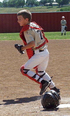Image: Italy Gold catcher, Taylor Sparks(7), hustles after a hit ball.