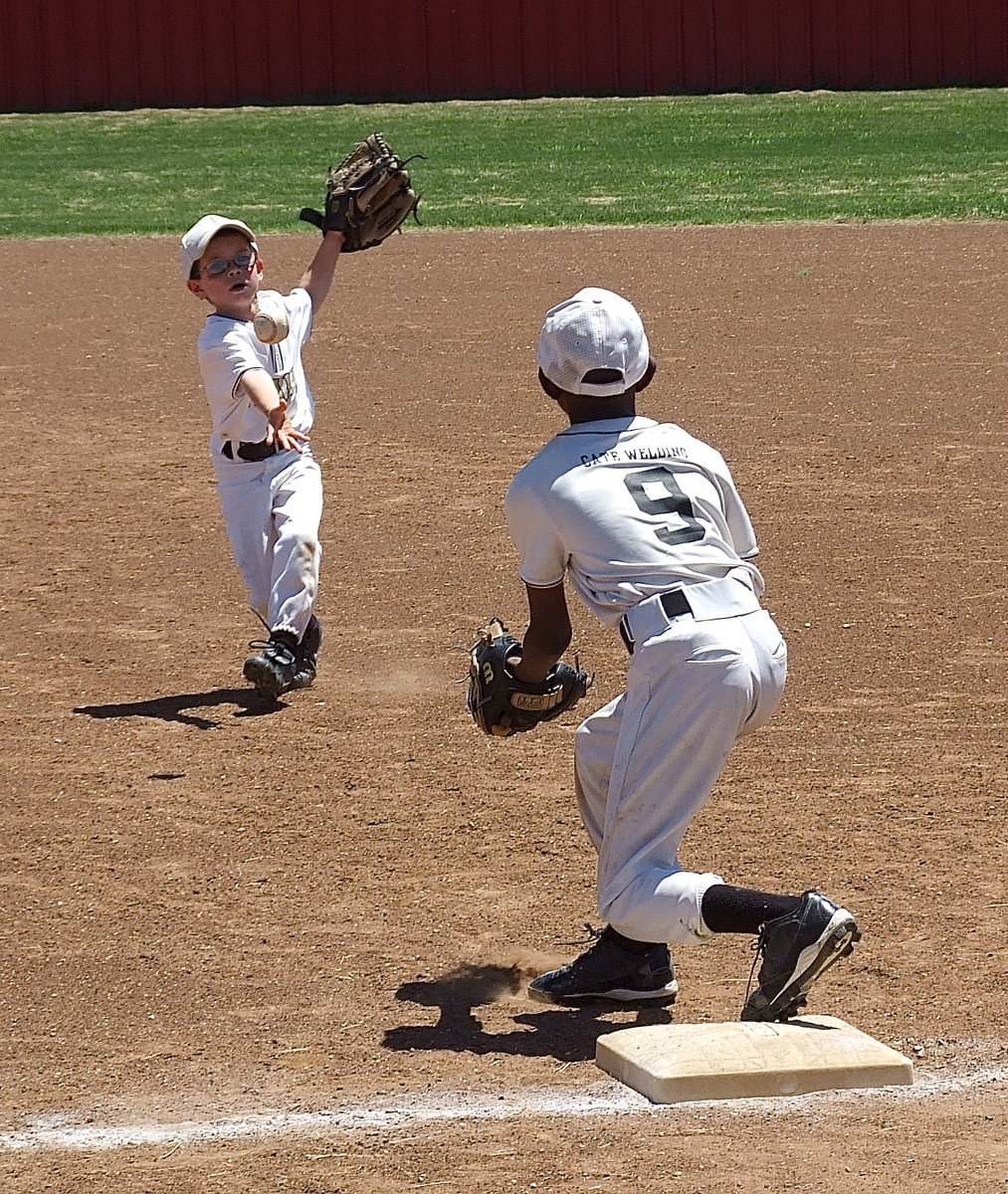 Image: Italy White’s second baseman, Austin Cate, covers a grounder and then tosses the ball to first baseman, John Hall(9).