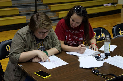 Image: Catherine Hewett and Lindsey Thompson contemplate the entries.