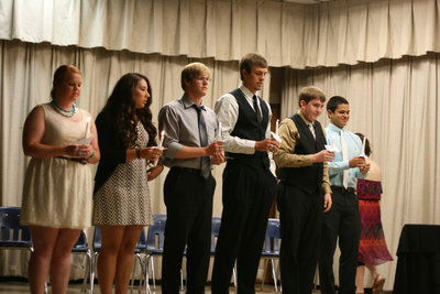 Image: The NHS Officers of 2012-2013 prepare to give their torch to the new officers.