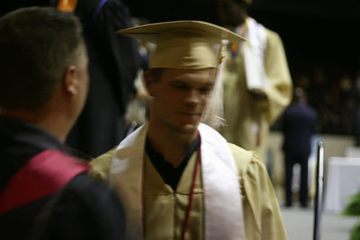 Image: Chase Hamilton is pleased to have Coach Ward move his tassel to the other side.