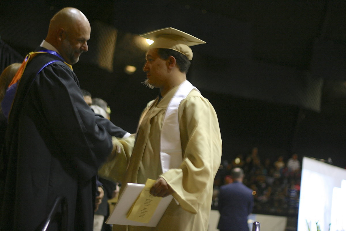 Image: Mr. Joffre gives Blake Vega a piece of advice before walking off the stage.