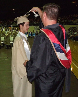 Image: Josh Ward adjusts the tassel for 2013 Italy High School graduate Marcus Sorels after Sorels received his diploma.