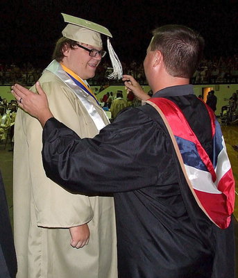 Image: Josh Ward adjusts the tassel for 2013 Italy High School graduate Logan Owens after Owens received his diploma.