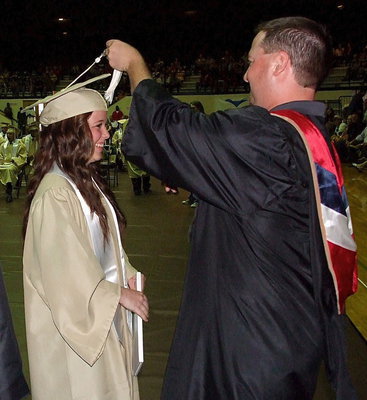 Image: Josh Ward adjusts the tassel for 2013 Italy High School graduate Felicia Little after Little received her diploma.