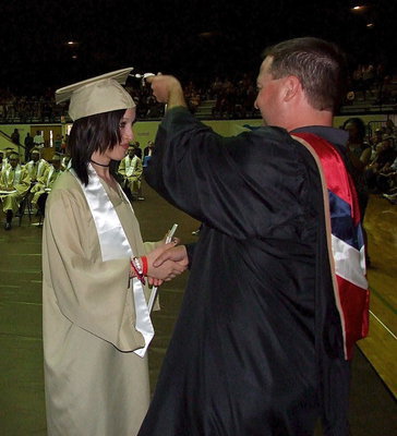 Image: Josh Ward adjusts the tassel for 2013 Italy High School graduate Mary Latimer after Latimer received her diploma.