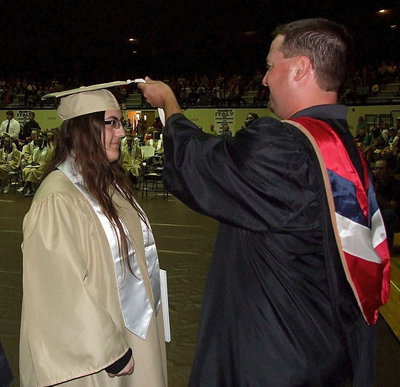 Image: Josh Ward adjusts the tassel for 2013 Italy High School graduate Morgan Junkin after Junkin received her diploma.