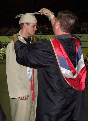 Image: Josh Ward adjusts the tassel for 2013 Italy High School graduate Chase Hamilton after Hamilton received his diploma.
