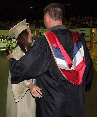 Image: Josh Ward adjusts the tassel for 2013 Italy High School graduate Morgan Cockerham after Cockerham received her diploma.